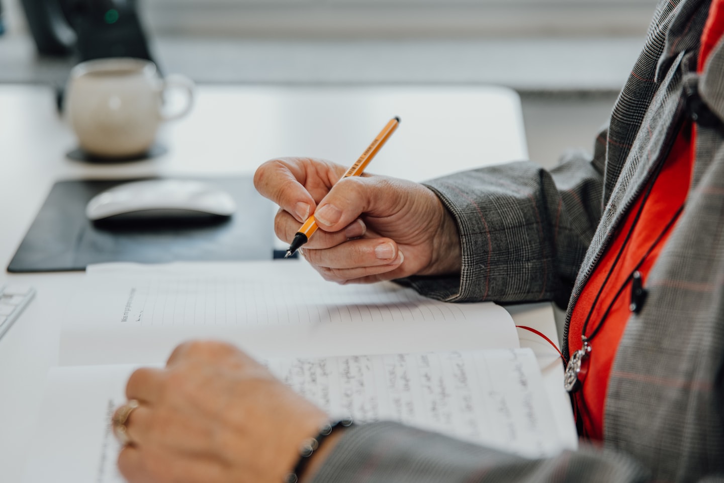 Writing notes with a pen.