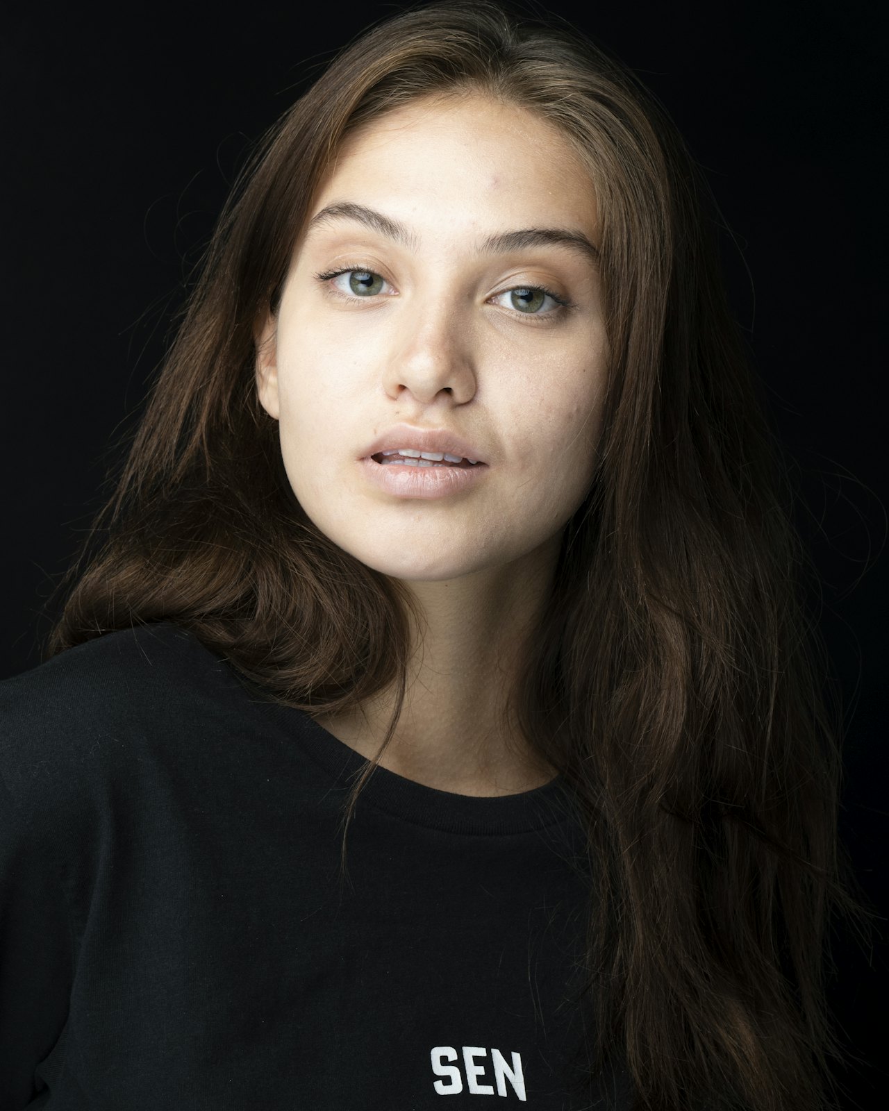 Person with long hair, dark shirt.