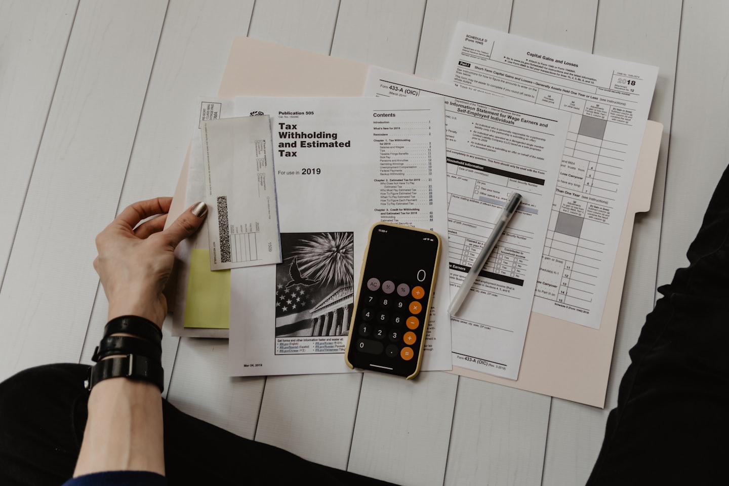 Tax documents and calculator on table